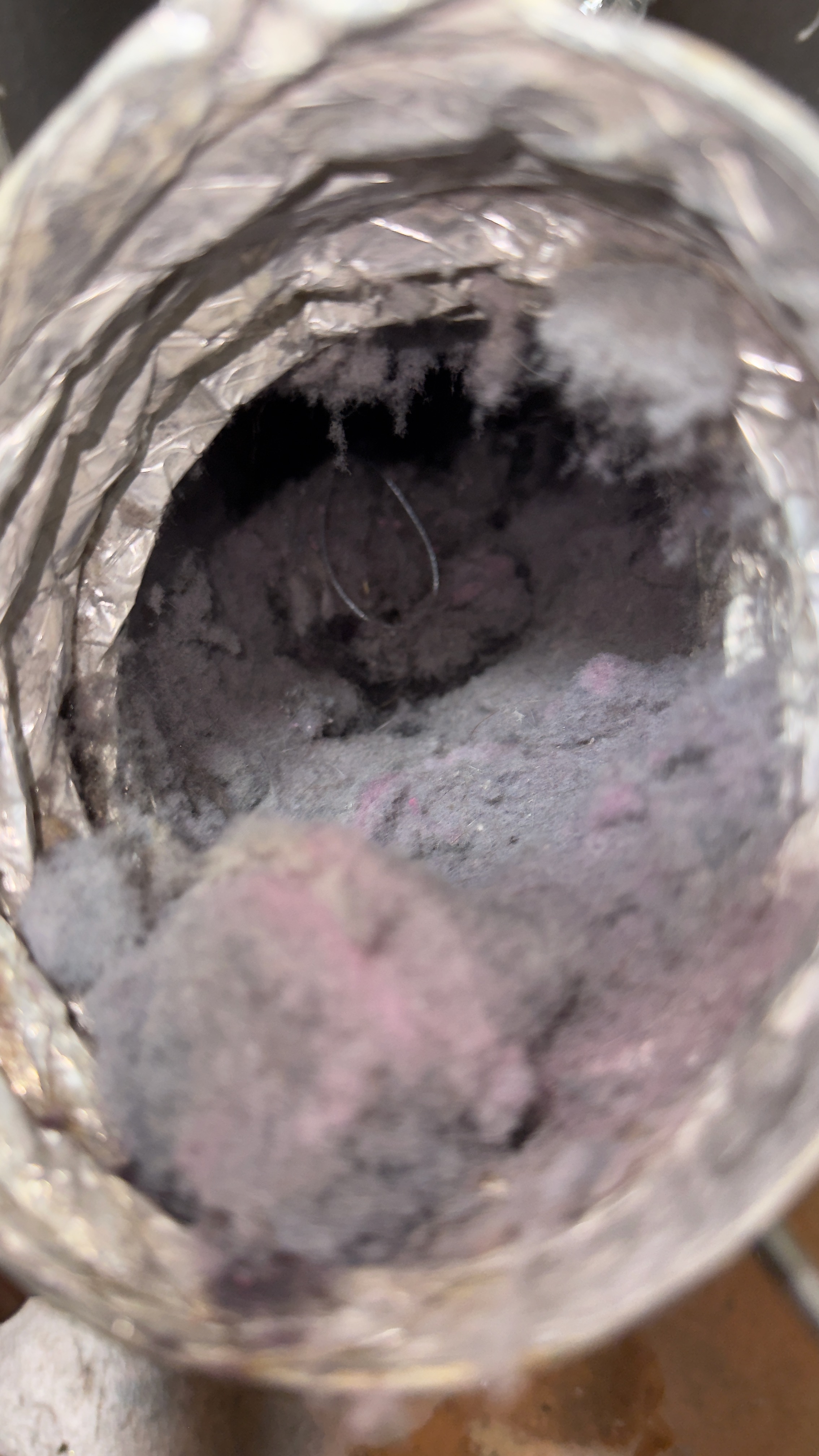 Dryer flex transition duct with heavy lint buildup before cleaning in Woodbridge VA